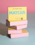 Happy Matcha box stack on pink and blue background
