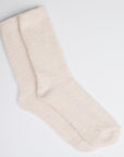 Two pink fuzzy socks on white background.