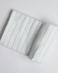 Powder Blue Stripe Swaddle on white background.
