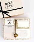 Gold coffee scoop, coffee caramels, cream mug and box of coffee packed in BOXFOX