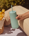 Woman at picnic holds Carter Cold Tumbler in Mint Chip