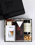 BOXFOX Matte Black Gift Box filled with Compartes The Nightcap Chocolate Bar, Corkcicle Whiskey Wedge Glass, Mielle Citrus Peeler, Art of Caramel Kentucky Bourbon Black Pepper Popcorn, Jack Rudy Cocktail Co. Aromatic Bitters and Jack Rudy Cocktail Co. Bourbon Cocktail Cherries