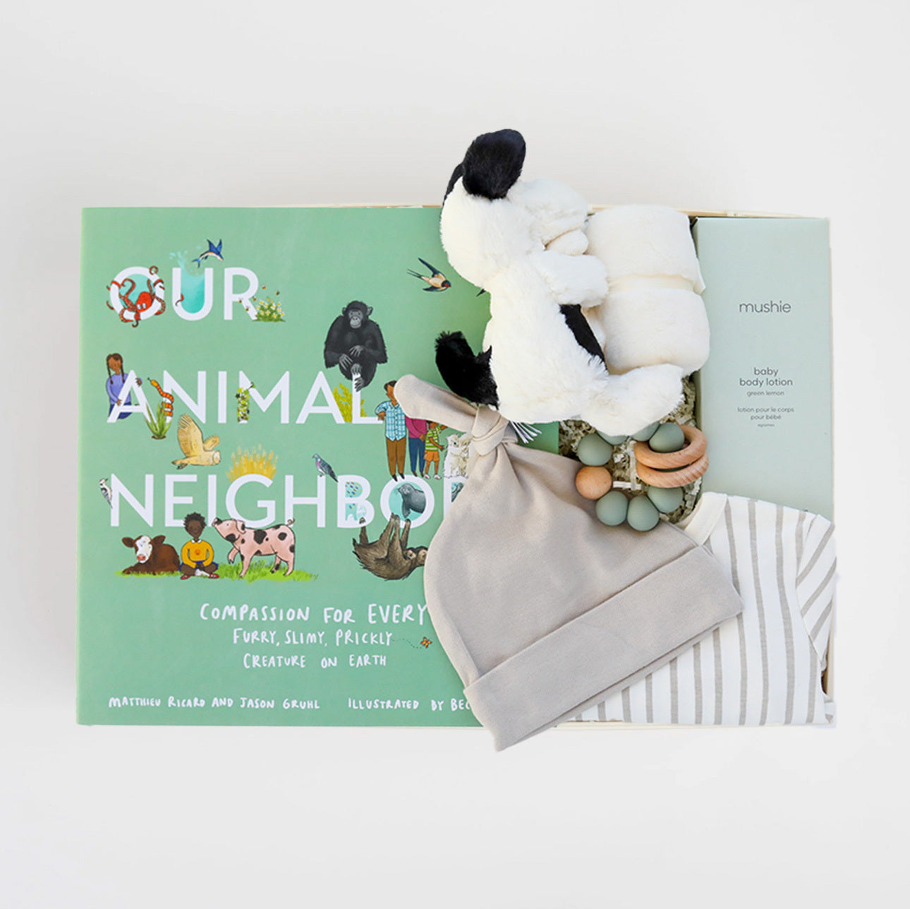BOXFOX Original creme New Family Gift Box packed with PEHR cozy grey striped onesie 3-6 months, Jellycat puppy lovey, Our Animal Neighbors book, Pipette baby oil, Alva sage green teether, and Alva grey beanie