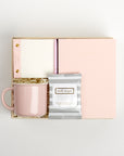 BOXFOX Original Creme Hustle Gift Box packed with Wit & Delight Pink Note to Self Journal, BOXFOX Pink Ceramic Mug, Well-Kept Hampton Tech Wipes, Sugarpaper Pink To Do Pad, and BOXFOX Pink Bullet Pen.