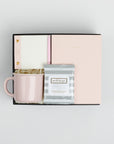 BOXFOX black Hustle Gift Box packed with Wit & Delight Pink Note to Self Journal, BOXFOX Pink Ceramic Mug, Well-Kept Hampton Tech Wipes, Sugarpaper Pink To Do Pad, and BOXFOX Pink Bullet Pen.