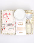 Table for Two ready to ship in creme featuring "Table for Two" cookbook, Le Creuset spoon rest, Branche olive oil, The Salt, and marble salt cellar