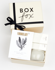 BOXFOX Creme Gift Box filled with Voluspa Coconut Papaya Tin Candle, Formulary 55 Eucalyptus + Peppermint Foot Soak and Mast Brothers 2 Mini Tea Chocolate Bars