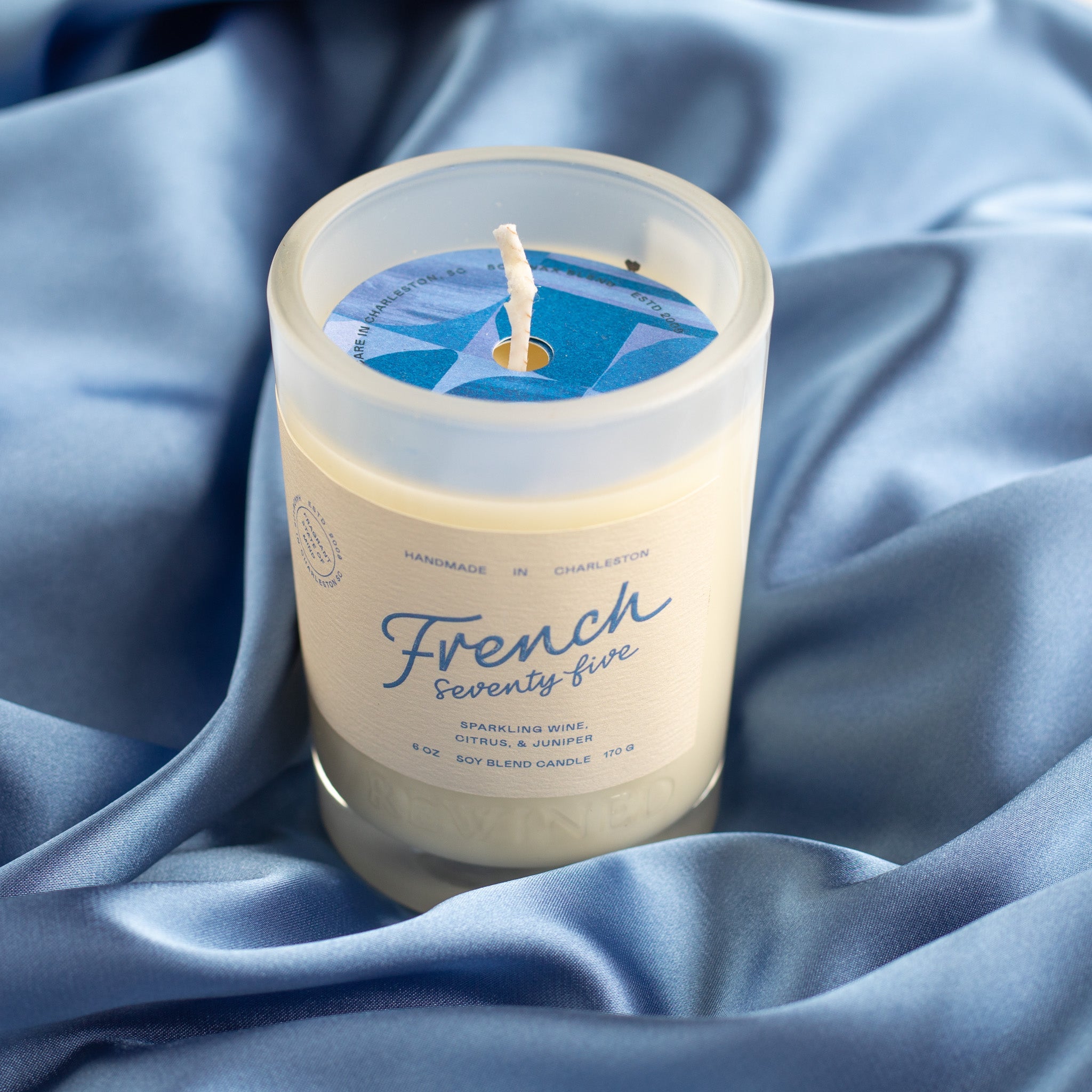 Frosted glass candle on blue silk
