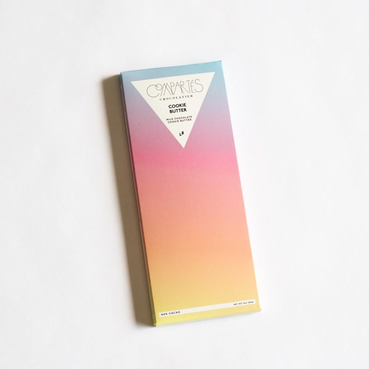 Cookie butter chocolate bar packaging that feature an ombre design that goes from blue to purple to pink to orange to yellow.