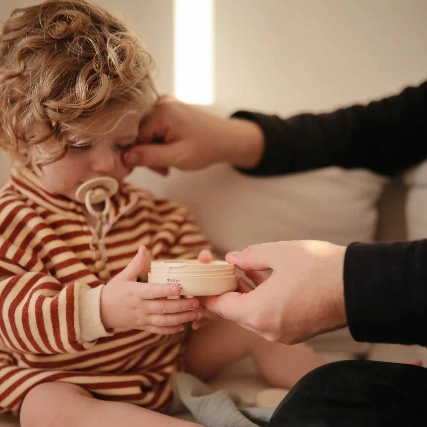 Mushie baby balm in use