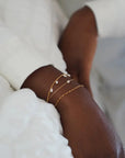 Poppy Pearl Bracelet on wrist with other bracelets 