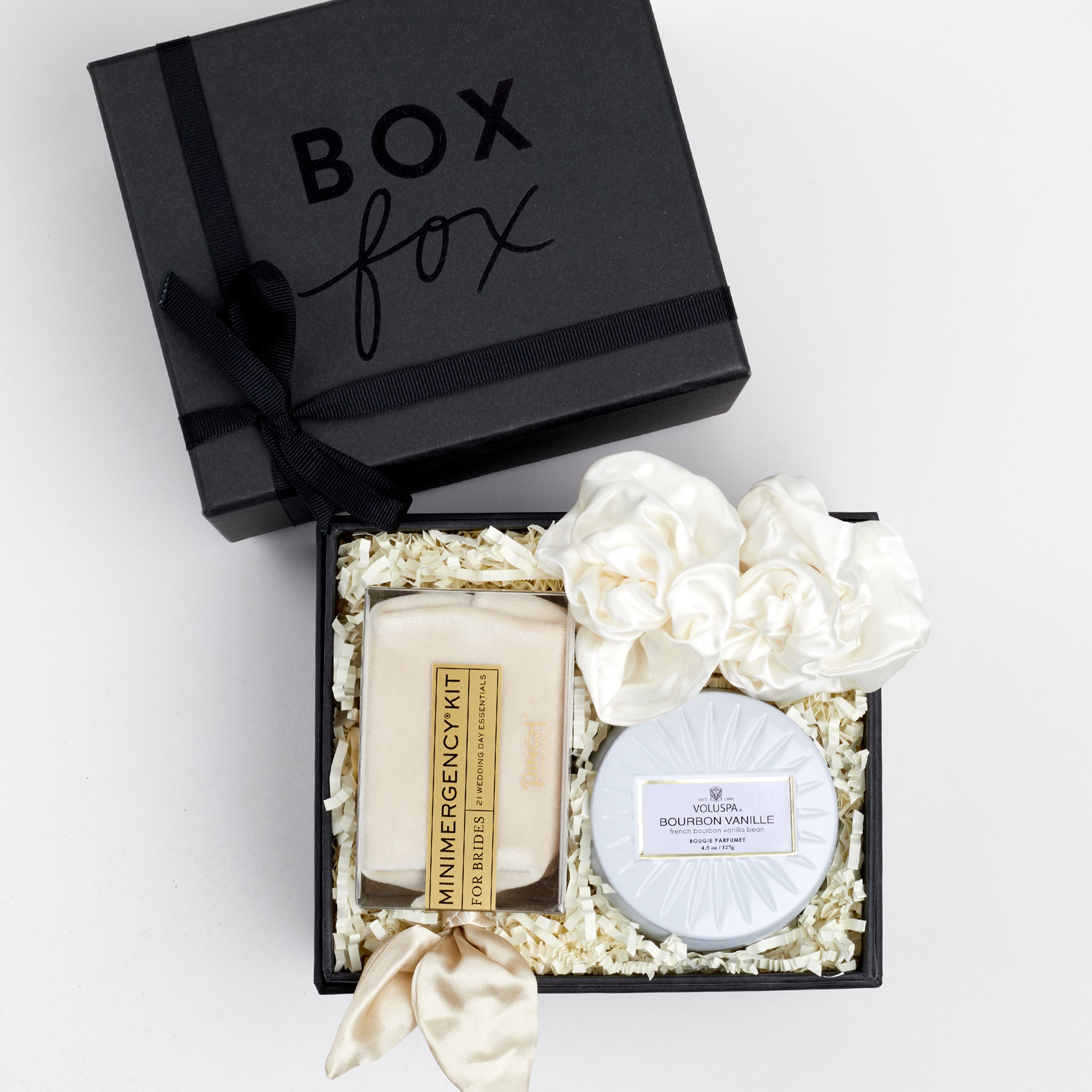 BOXFOX Matte Black Gift Box with Pinch Provisions Ivory Velvet Bridal Emergency Kit, Voluspa White Tin Candle and 2 Ivory Silk ScrunchiesBOXFOX For the Bride Gift Box filled with Ivory crinkle paper