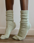 girl on tippy toes wearing green socks