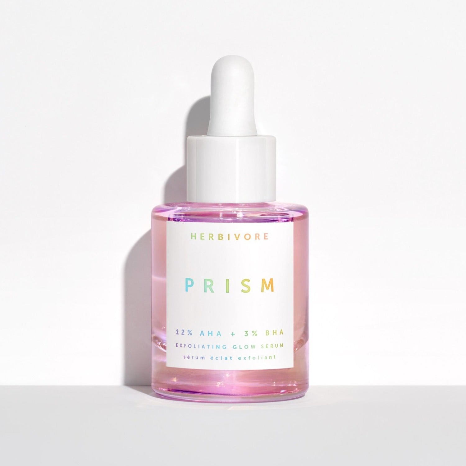 Pink iridescent serum with white dropper cap and white label.