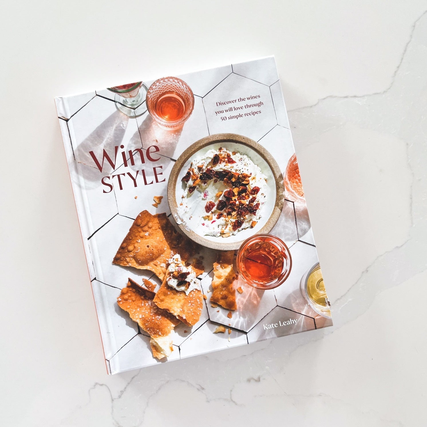 Wine style book on white marble background.