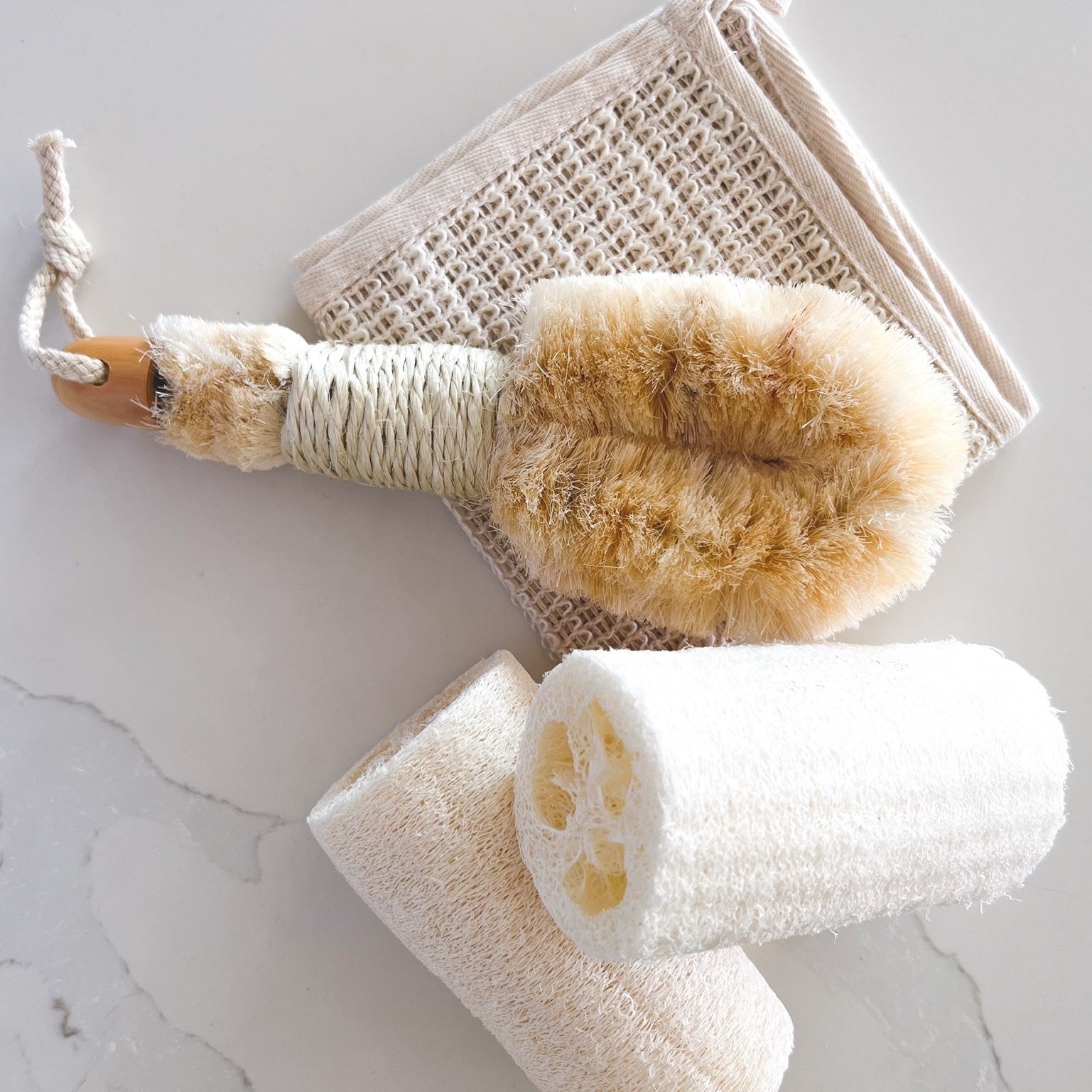 Nordic dry brush pictured with natural loofash and sisal washcloth