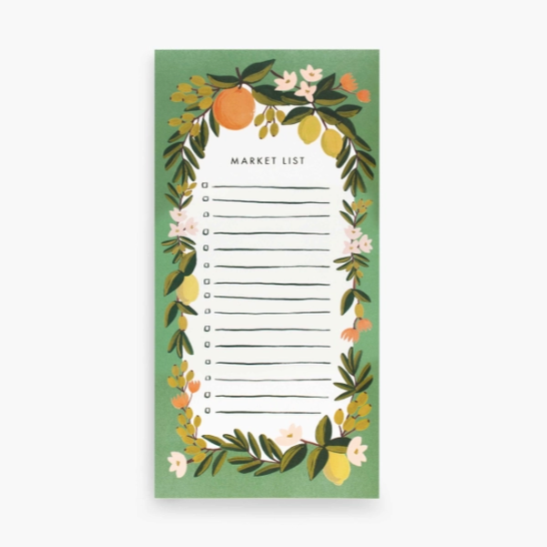 Rectangular notepad with &quot;Market List&quot; text at top center above blank bullet list surrounded by green border and painted foliage photographed on white background
