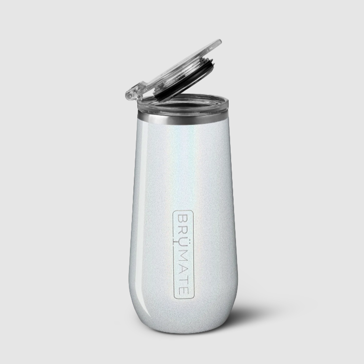 A white glitter, champagne flute shaped insulated thermos with clear plastic lid photographed on white background