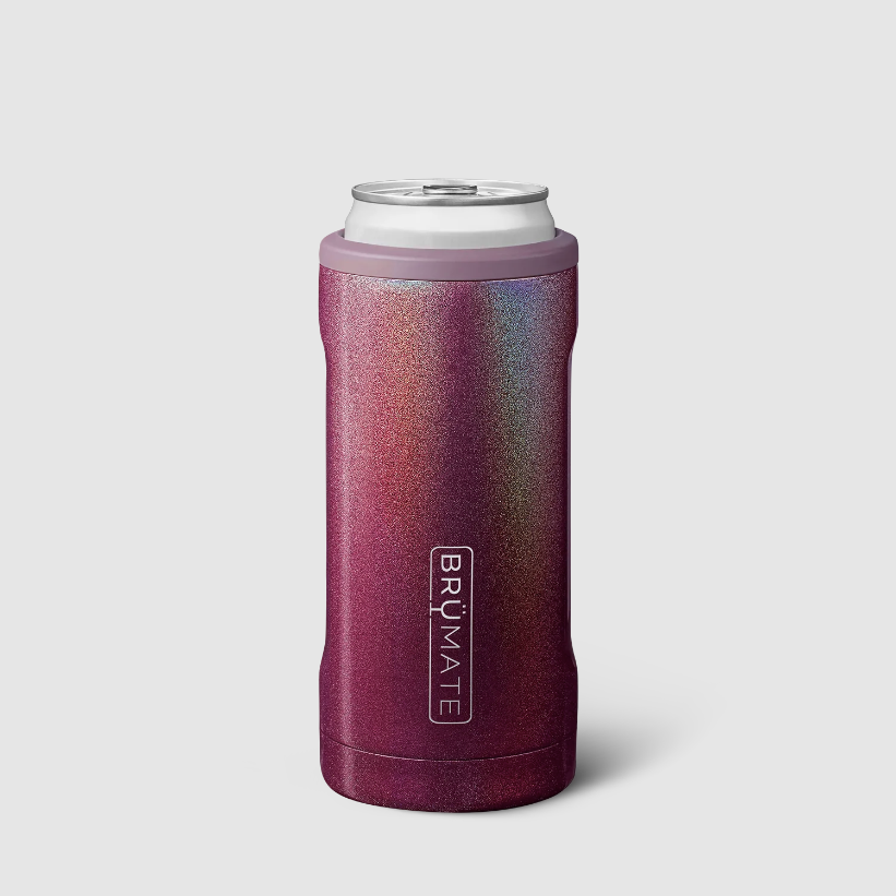 A pink-purple insulated can holder with iridescent sparkle all over holding a can inside photographed on light grey background.