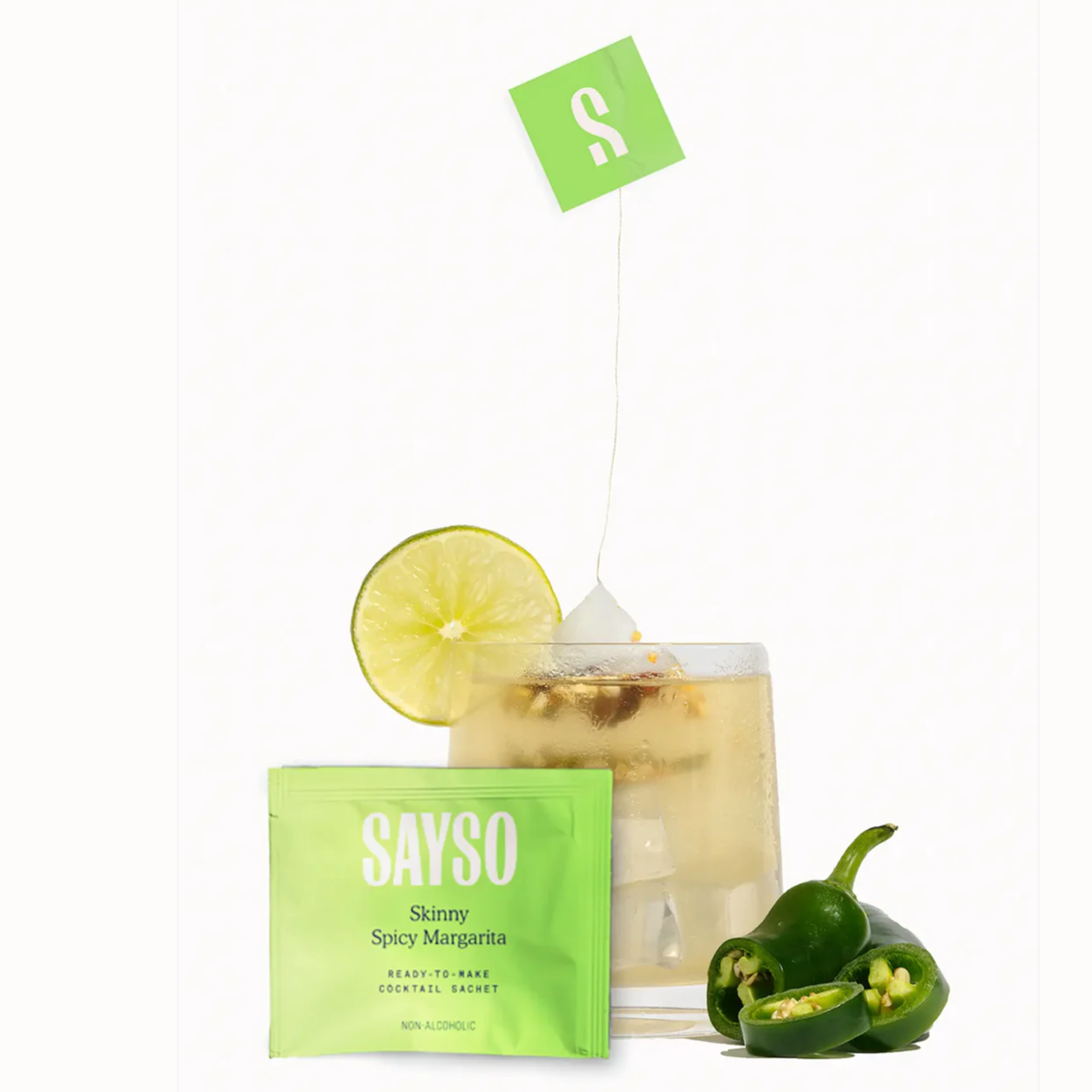 Image shows the SAYSO Skinny Spicy Margarita sachet, a cocktail with the sachet soaking, and sliced jalepeno. 