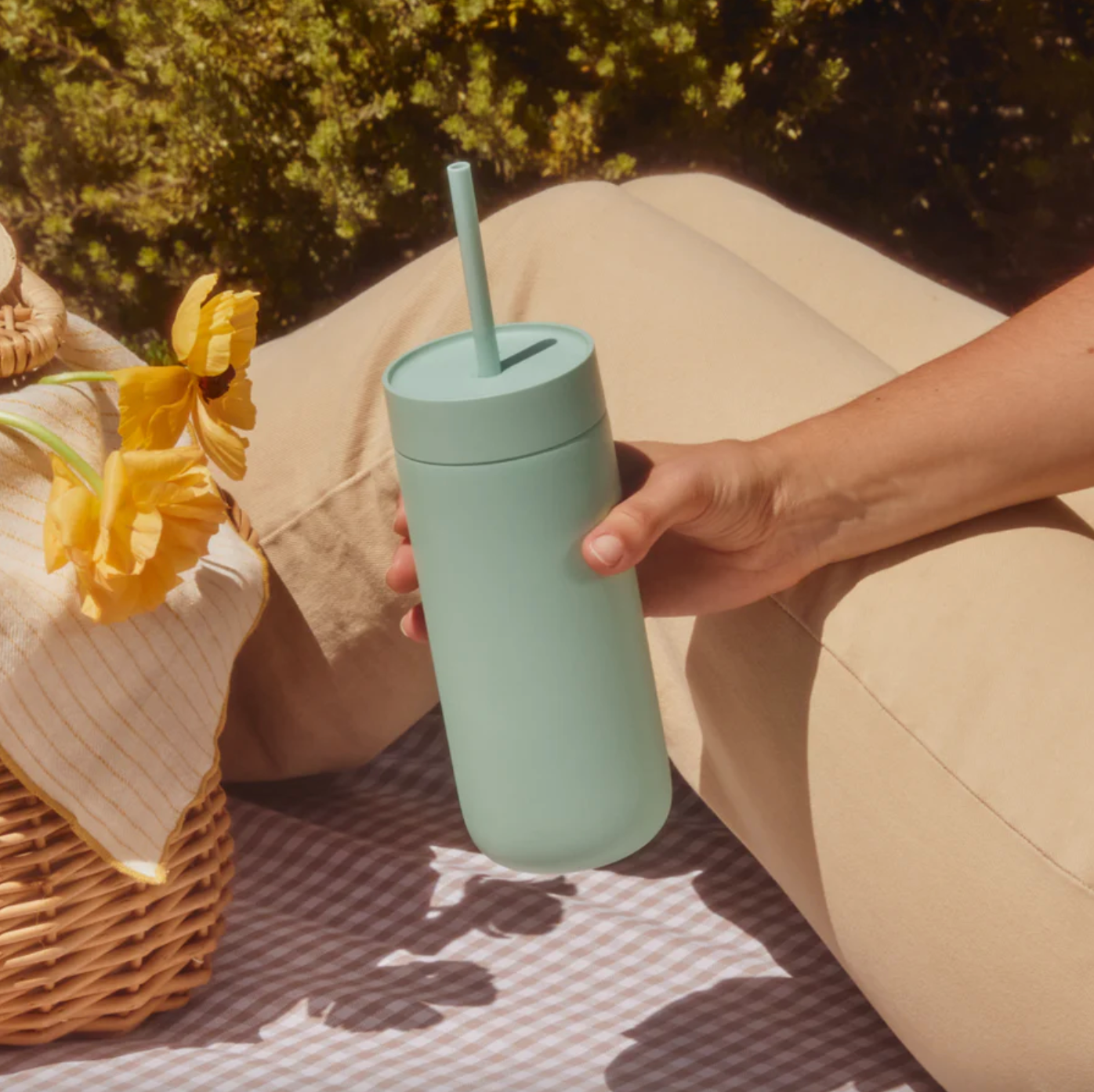 Woman at picnic holds Carter Cold Tumbler in Mint Chip