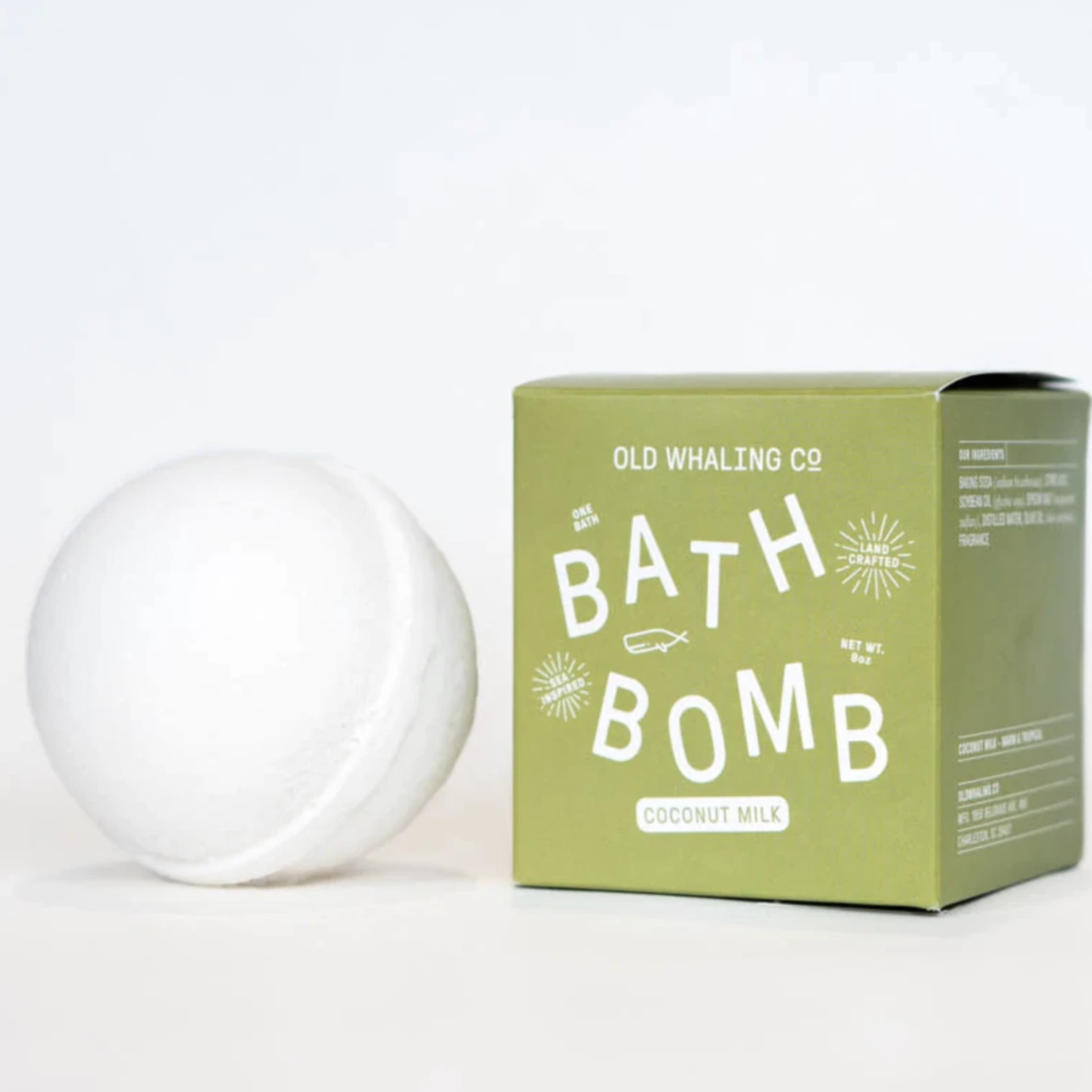White bath bomb on the left and green cube box to the right.