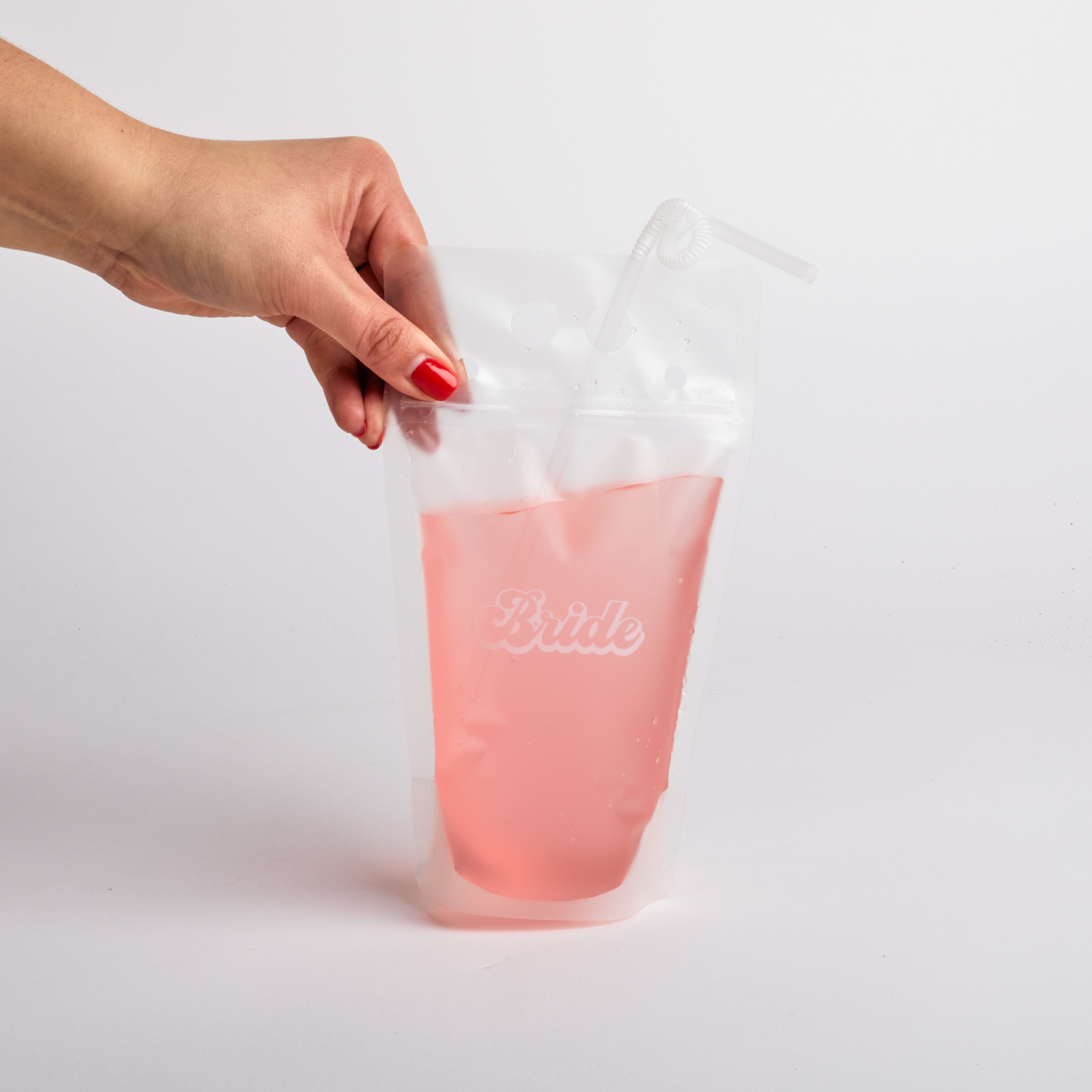 Hand holding &quot;bride&quot; drink pouch.