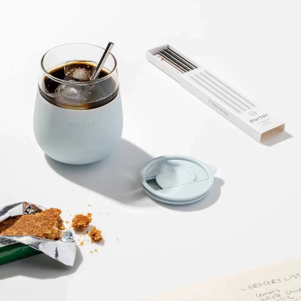Mint Glass Cup with drink, ice and straw in it, next to granola bar and straw set.