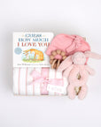 BOXFOX creme gift box next to open box containing a book, swaddle, teether, baby beanie and bunny rattle.