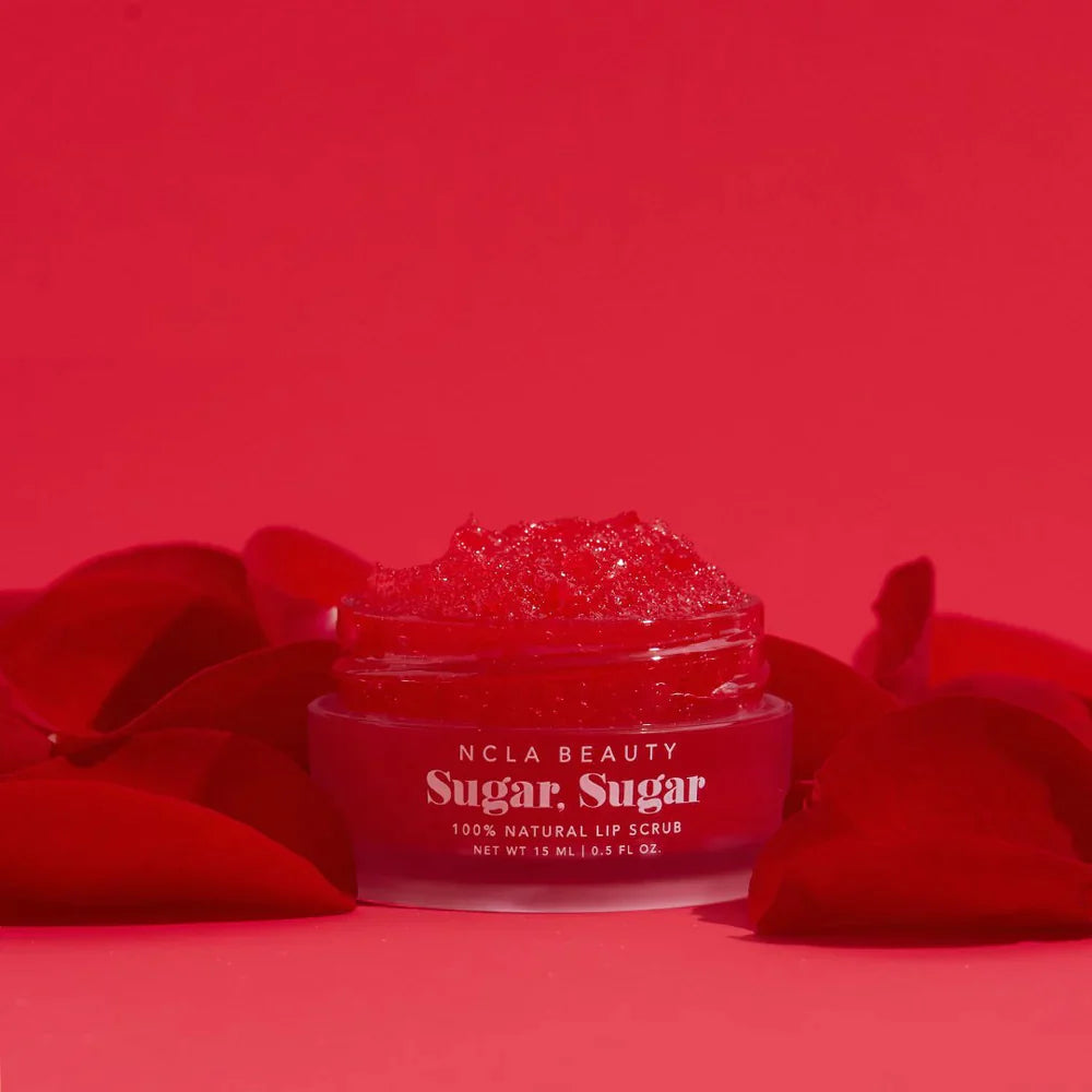 Red Roses Lip Scrub pot surrounded by rose petals on red background