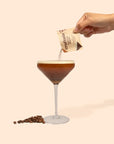 Espresso martini glass with hand pouring mix into it