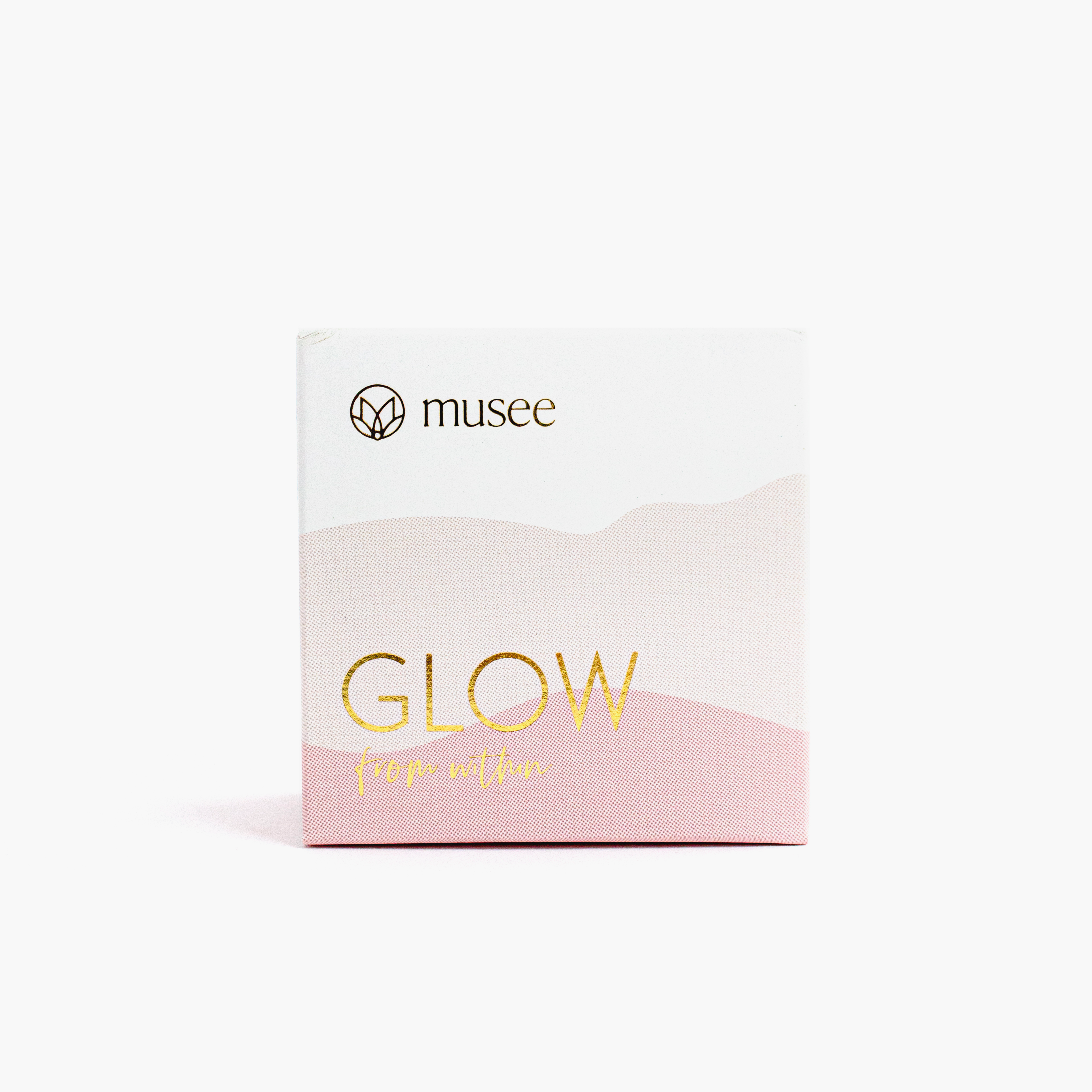Pink box of soap bar with gold foil writing reading "Glow from within"