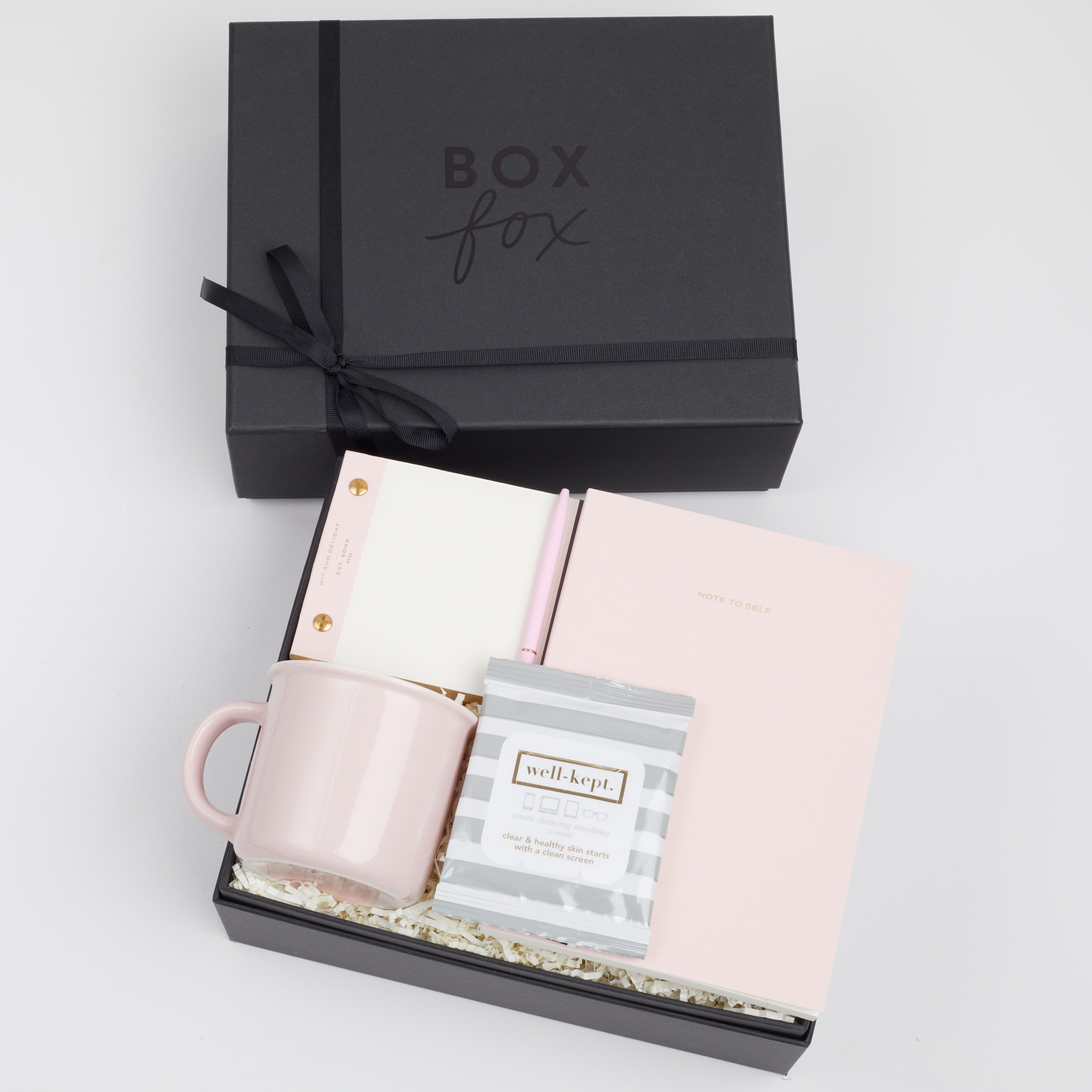 BOXFOX black Hustle Gift Box packed with Wit &amp; Delight Pink Note to Self Journal, BOXFOX Pink Ceramic Mug, Well-Kept Hampton Tech Wipes, Sugarpaper Pink To Do Pad, and BOXFOX Pink Bullet Pen.