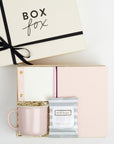 BOXFOX Original Creme Hustle Gift Box packed with Wit & Delight Pink Note to Self Journal, BOXFOX Pink Ceramic Mug, Well-Kept Hampton Tech Wipes, Sugarpaper Pink To Do Pad, and BOXFOX Pink Bullet Pen.