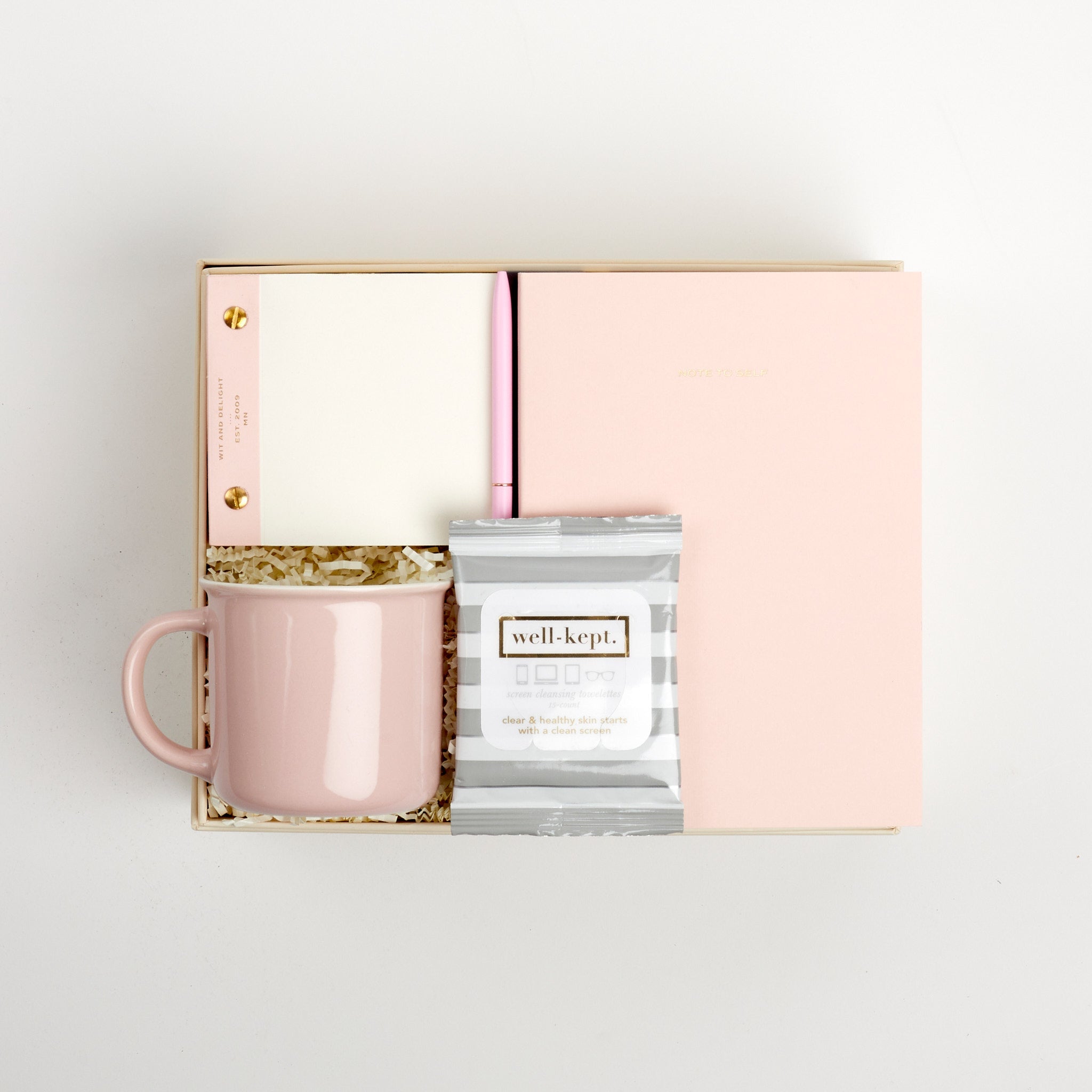 BOXFOX Original Creme Hustle Gift Box packed with Wit & Delight Pink Note to Self Journal, BOXFOX Pink Ceramic Mug, Well-Kept Hampton Tech Wipes, Sugarpaper Pink To Do Pad, and BOXFOX Pink Bullet Pen.