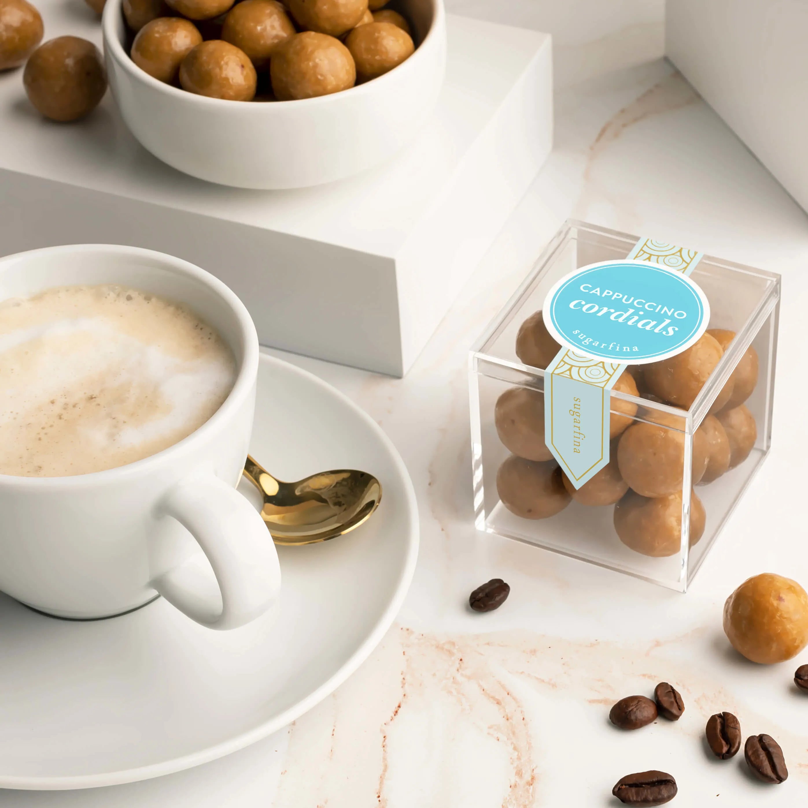 Cappuccino Cordials in dish and in candy cube, next to coffee on saucer